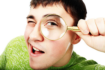 student with magnifying glass