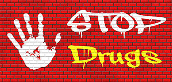 brick wall with graffiti "stop drugs"