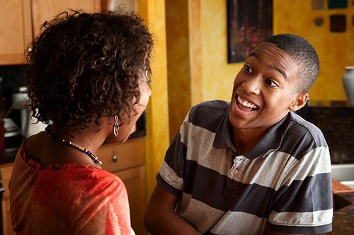 two people talking and looking surprised and happy