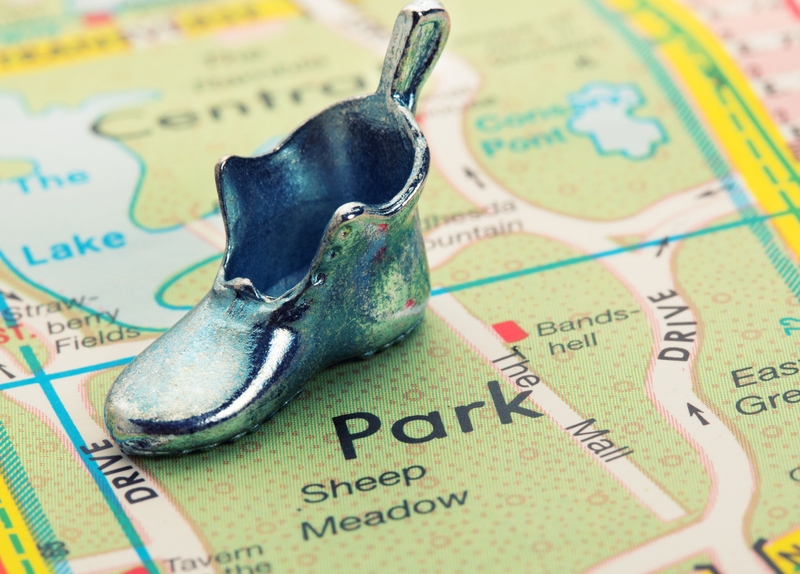 map with a silver metal shoe resting on top