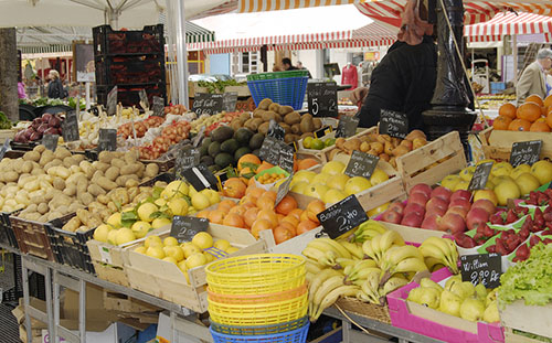 open-air market with fruits and vegetables on display