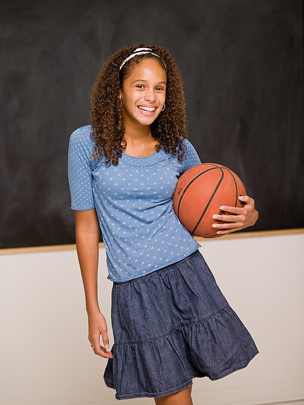 female student holding a basketball