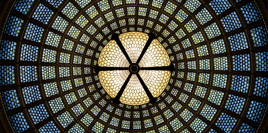 A circular pattern on a ceiling divided by beams