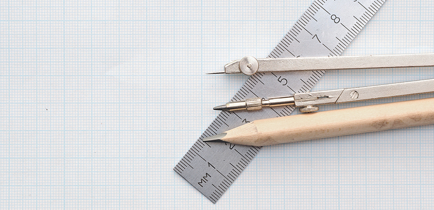 a pencil, compass, and ruler on top of graph paper