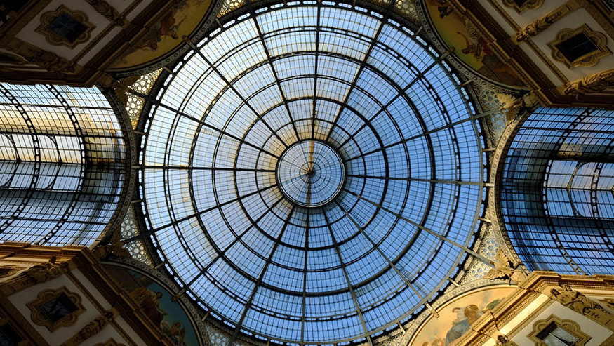 a circular glass dome ceiling with steel supports making additional shapes