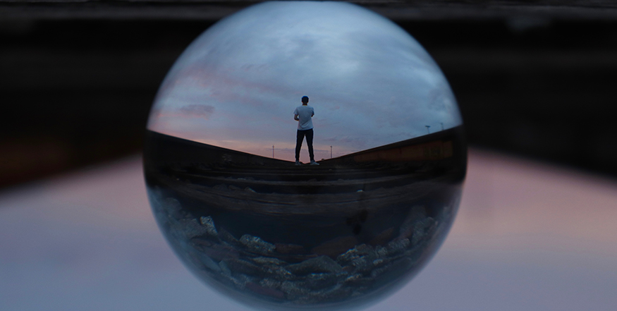 A teenager standing inside of a sphere