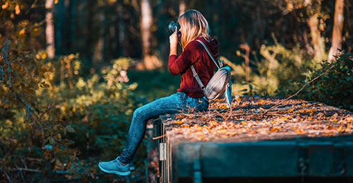 student outdoors taking a photo