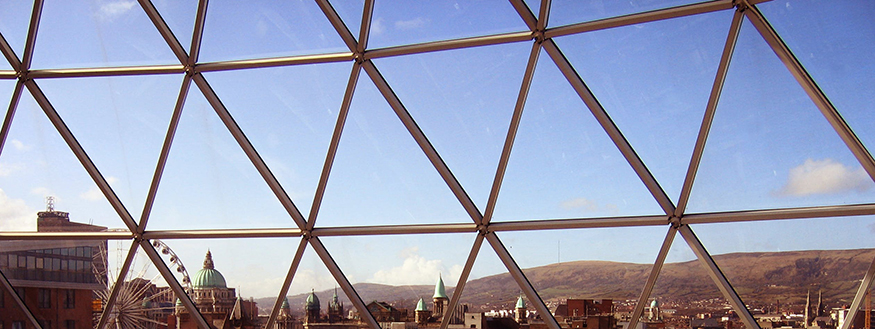 Window frame constructed of triangles overlooking a European city