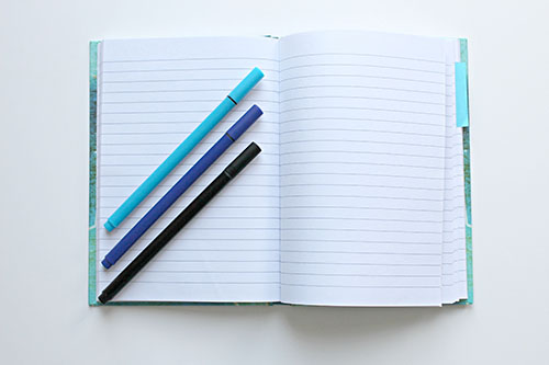 a notebook and pens