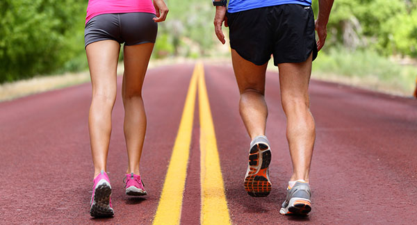 male and female running down the road