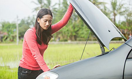 Woman with overheating car