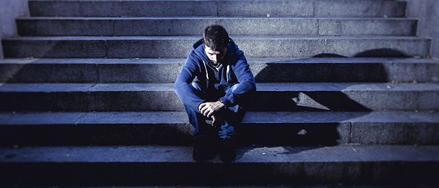 Depressed man sitting on steps