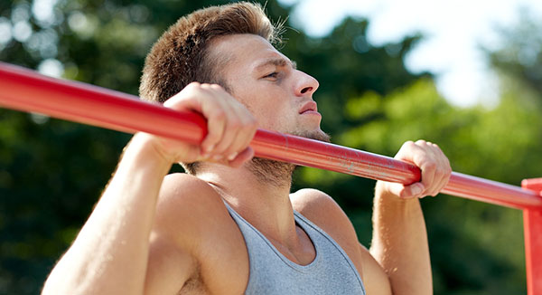 man doing a pullup outside