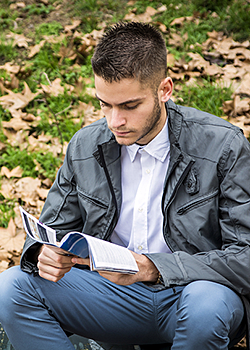 Young man reading a pamphlet