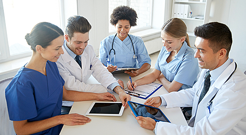 Medical staff using various technological devices