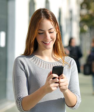 Happy teen looking at smart phone