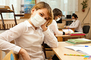 a student wearing a mask over her mouth