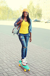 female skateboarding down the street