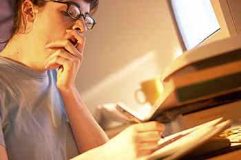 Student yawning while studying