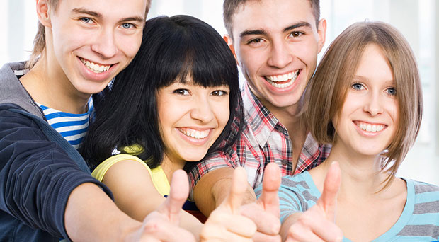 Group of happy students with thumbs up