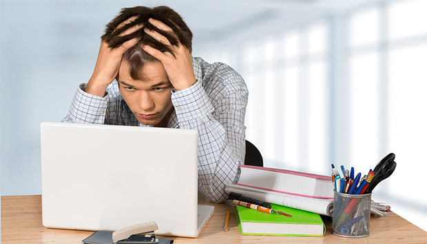 Teenager at desk looking frustrated