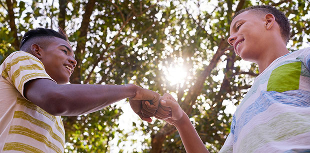 Two teens "fist-bumping"