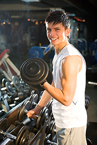 Teenage boy lifting weights