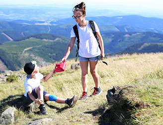 Two teenage hikers using a first aid kit