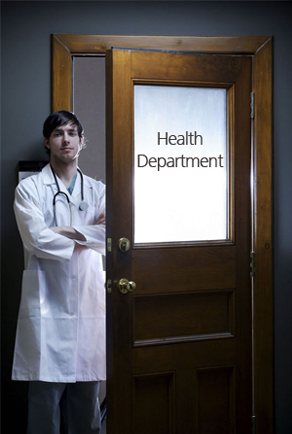 Young doctor standing in the doorway with the door labeled Health Department