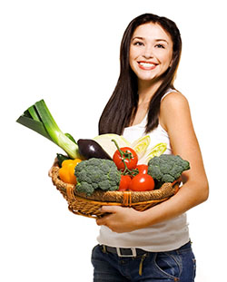 girl holding a basket of fresh vegetables