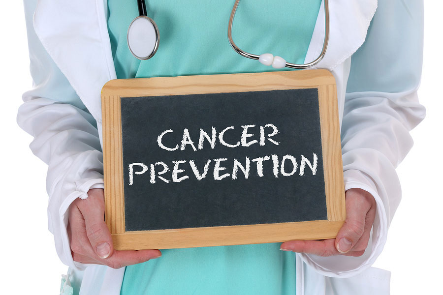 doctor holding sign that says "cancer prevention"