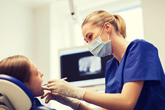 dentist cleaning a patient's teeth