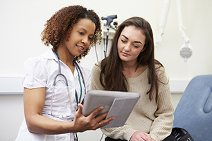 Teenage girl speaking with ther female doctor