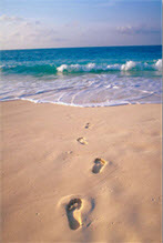 footprints in sand to sea