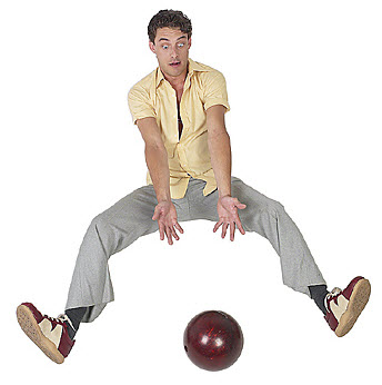 man dropping bowling ball