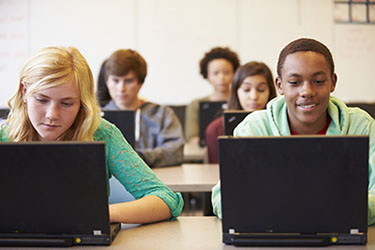 Students using laptops in a classroom