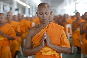 Buddhist monk from Thailand in meditation pose