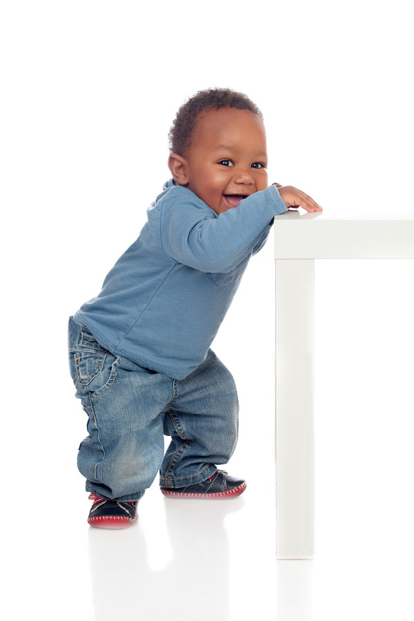 A baby pulling himself up to stand