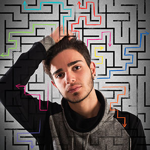 teenage male with a maze behind him