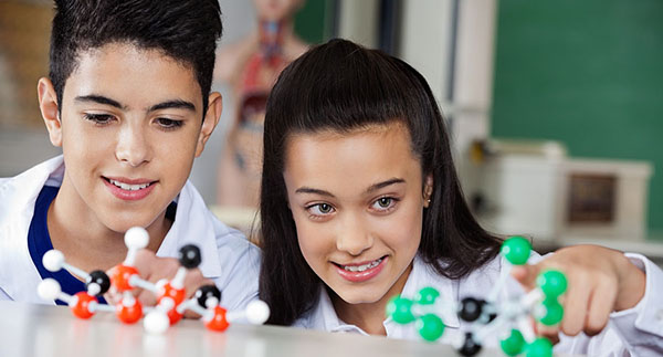 two students examing molecules