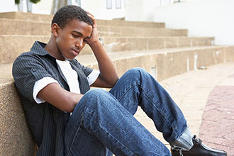 Sad student stiing on stairs