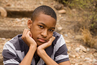 depressed male with head resting on hands