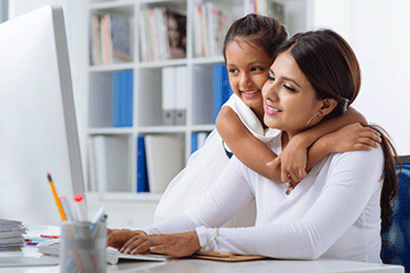 a mother and her daughter on a computer