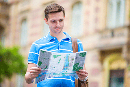 a male traveler holding a map