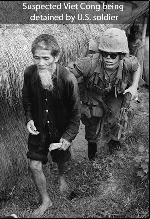 Image of suspected Viet Cong being detained by U.S. soldier.