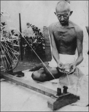 Image of Gandhi spinning his own cloth.