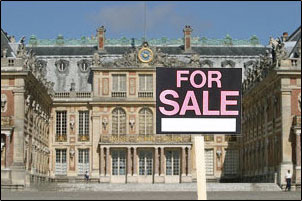 Image of Versailles with a for sale sign in front. 