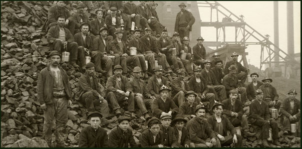 Image of miners sitting on waste rock.