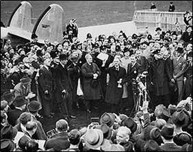 Image of Neville Chamberin speaking to reporters.